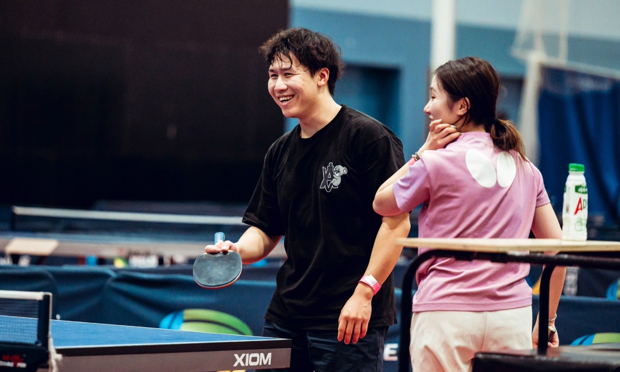 Two RMIT students playing on a doubles table tennis team at Melbourne Sports and Aqautic Centre.