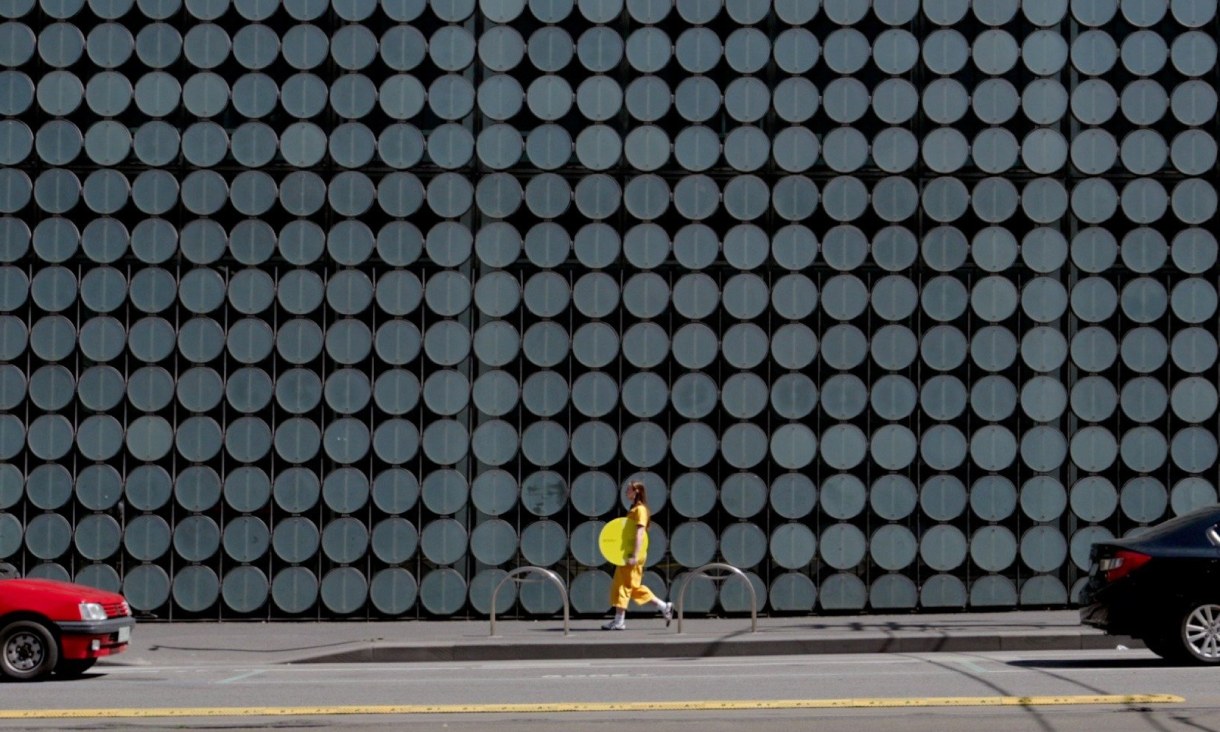 Two students smiling at camera holding their handmade artwork