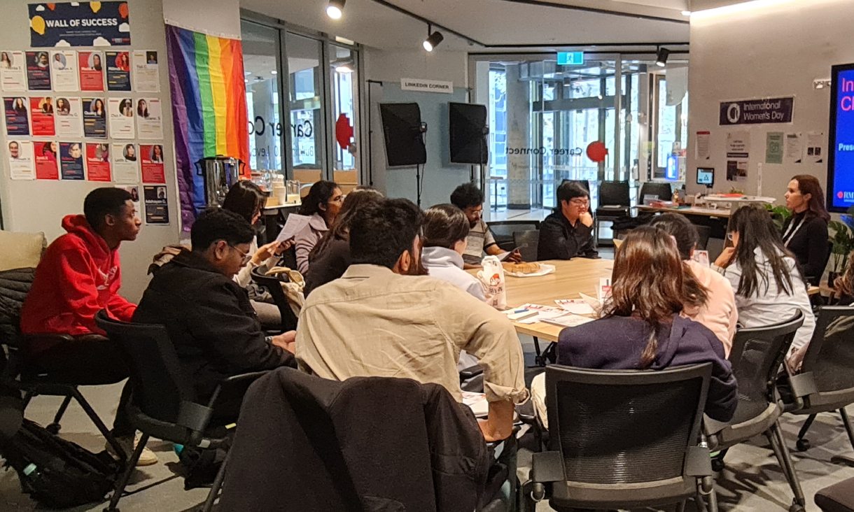 Students sit around a table in RMIT's Career Connect engaging in a workshop on careers.