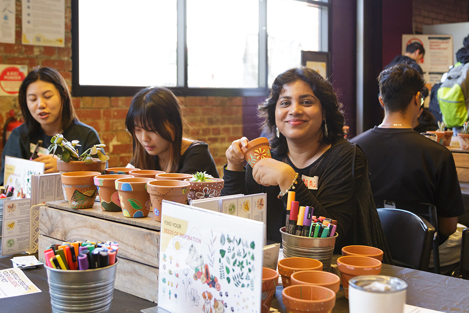 A student painting a pot