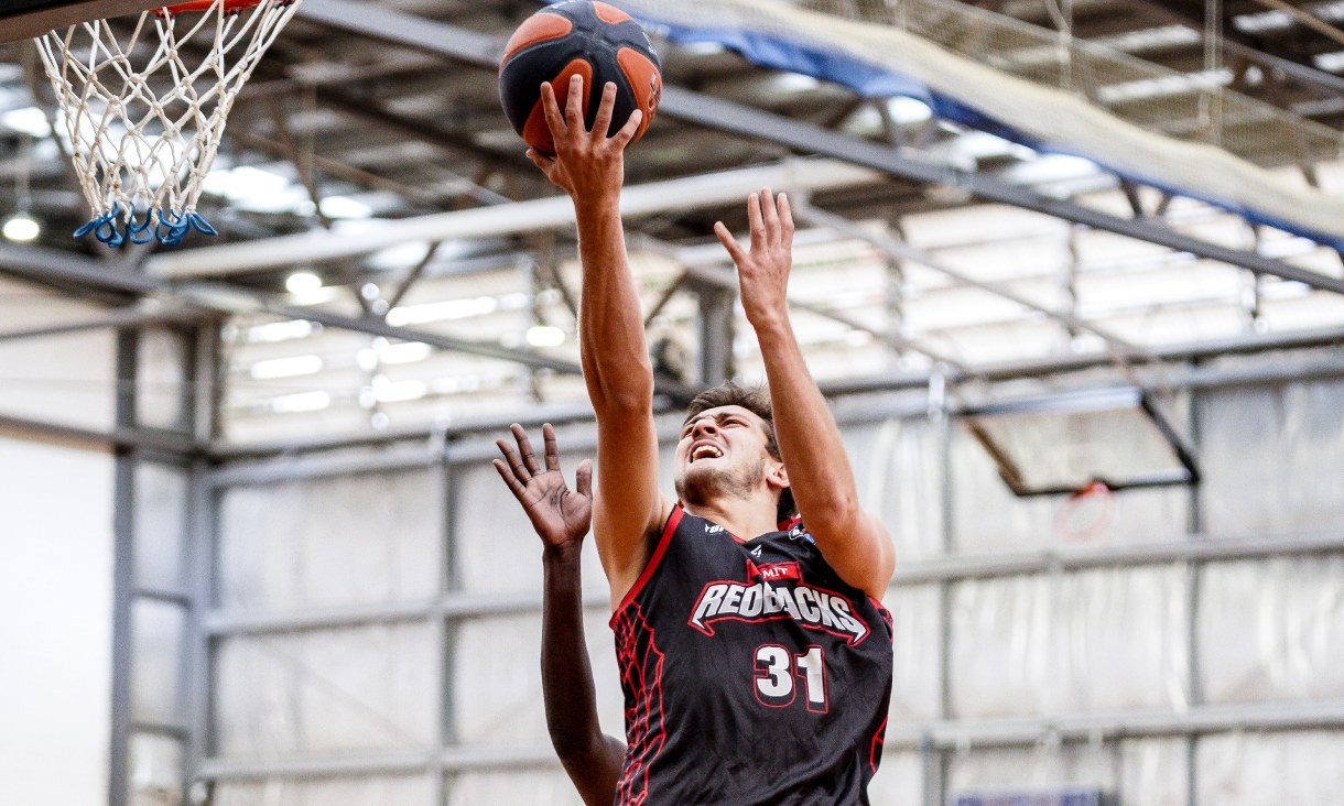 RMIT Redbacks basketball player mid-lay-up during a game