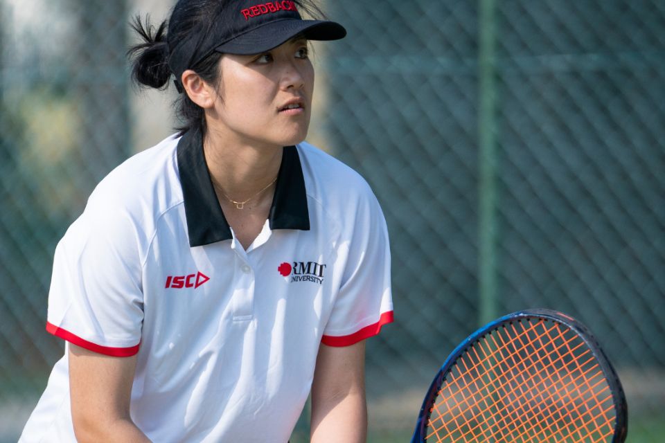 Student playing tennis