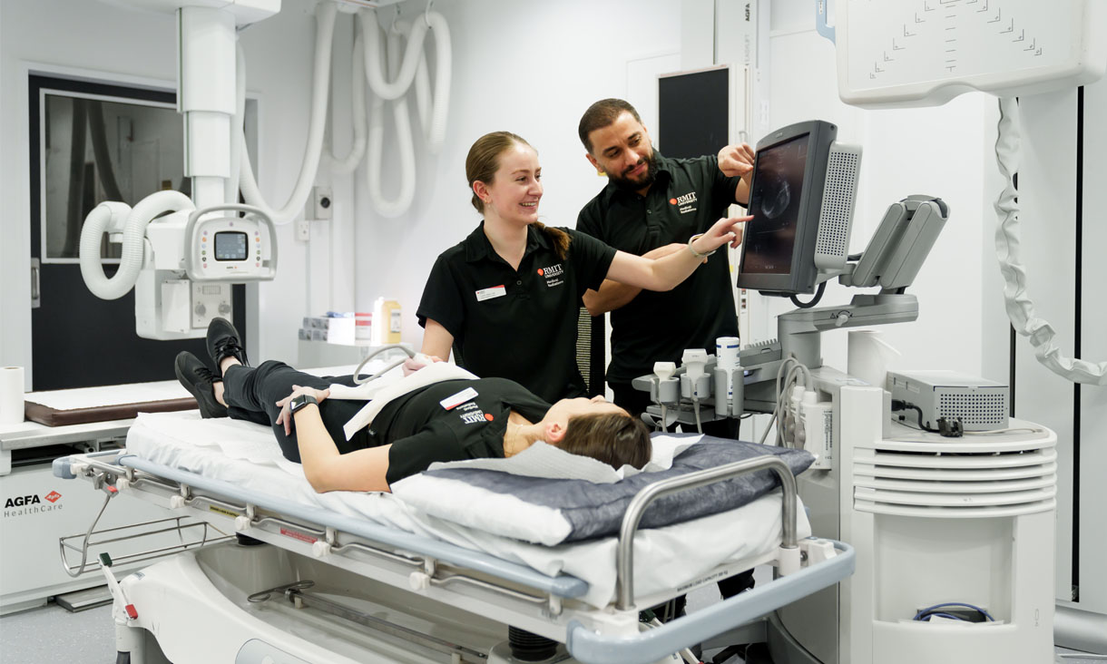 Two RMIT nursing students doing a simulation of patient care in a medical lab