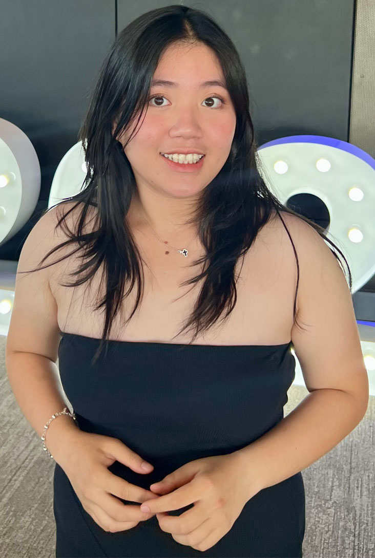 A young woman smiles at the camera.