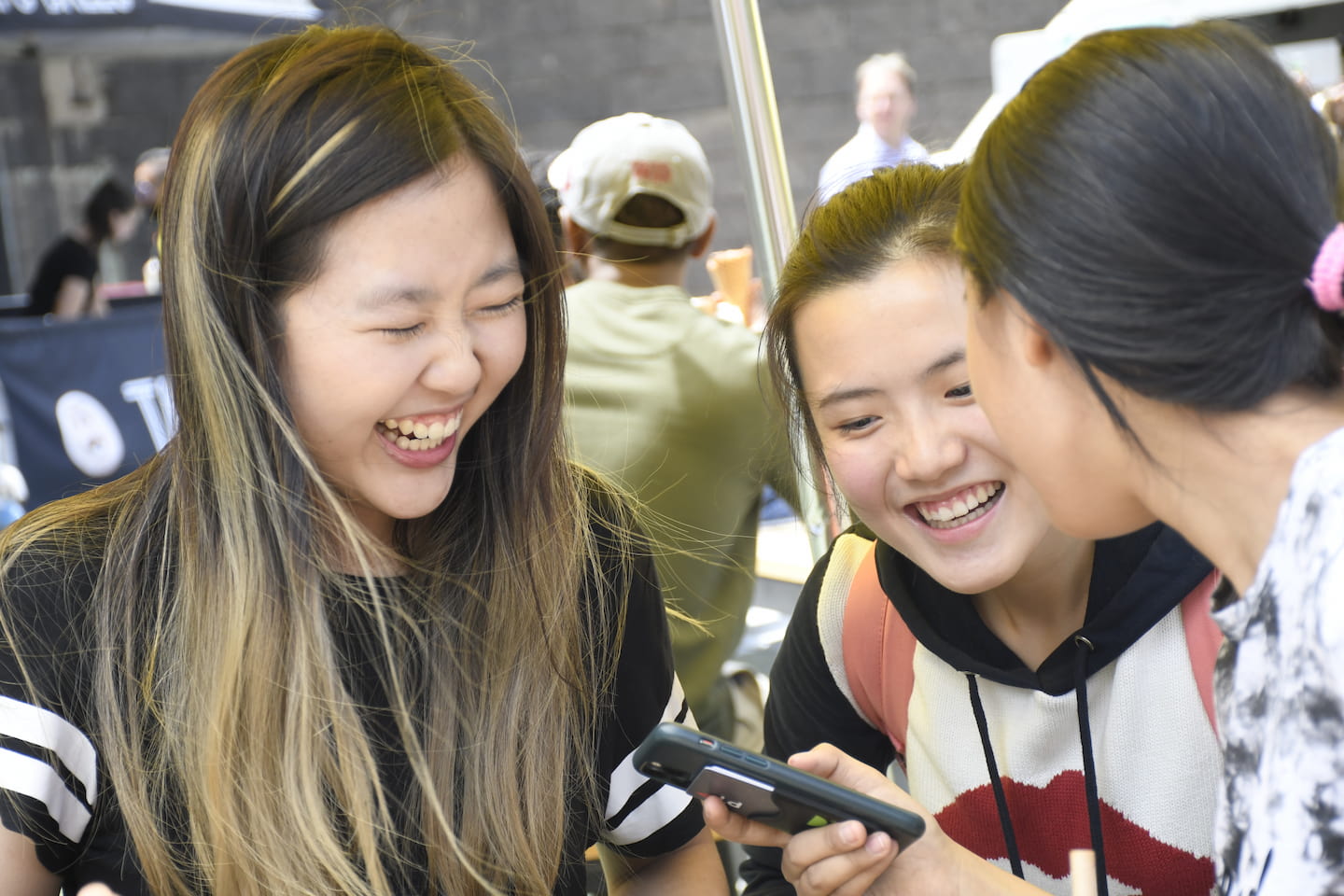 Smiling students with a phone