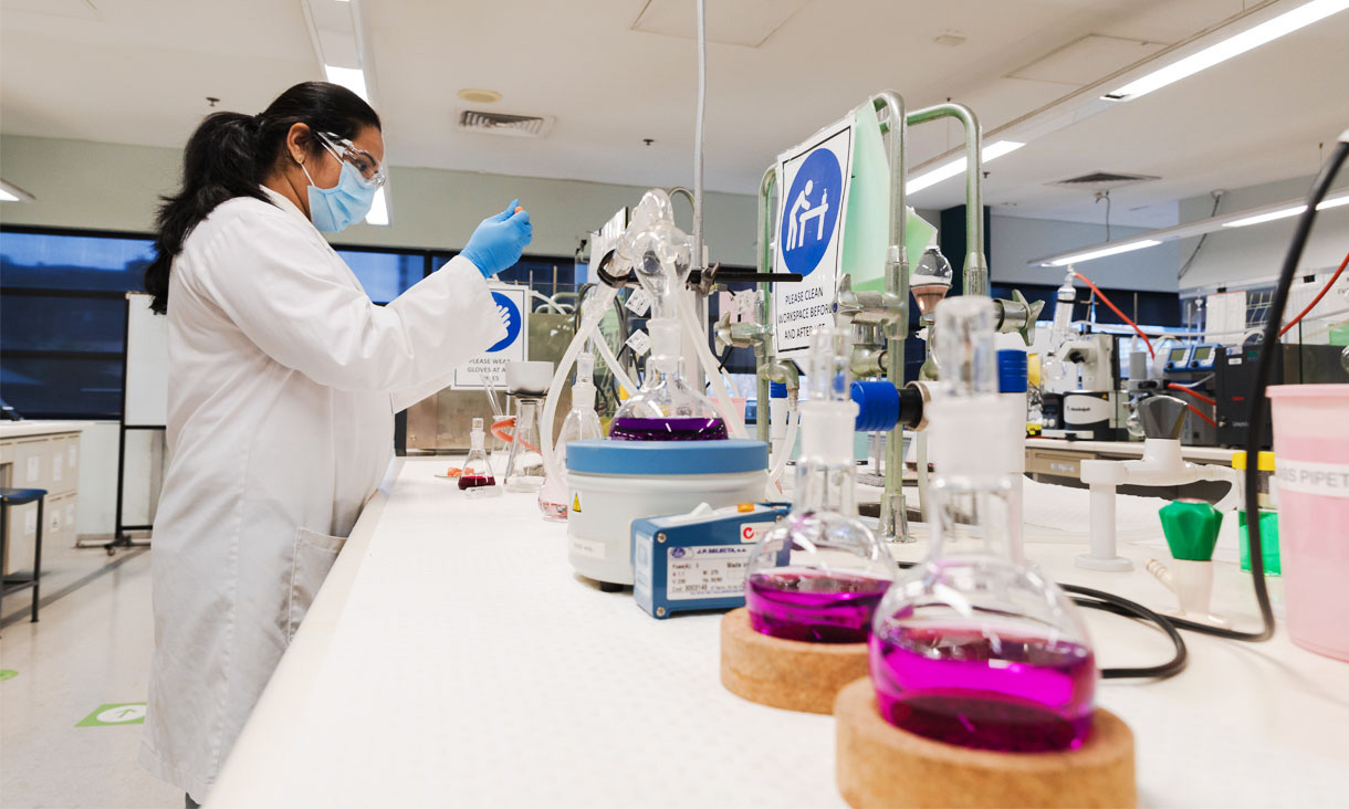 A chemist in a lab performing a test.