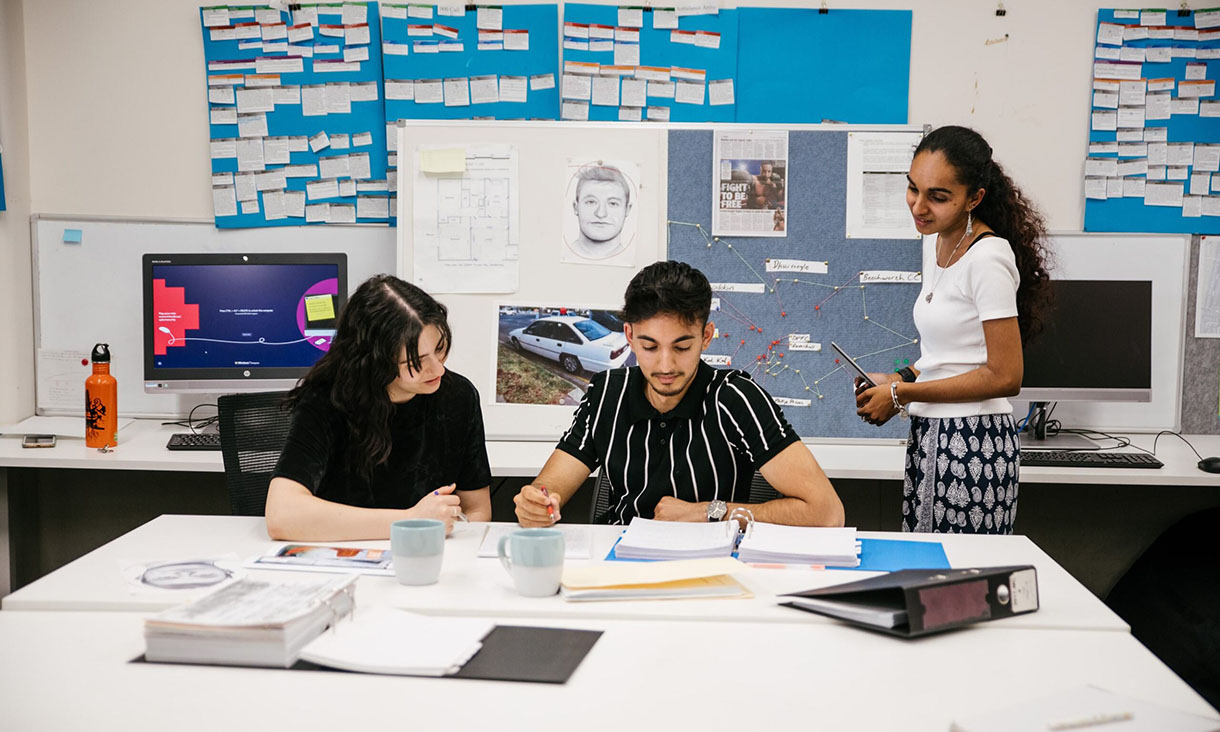 3 RMIT criminology students work together to solve a case in class.