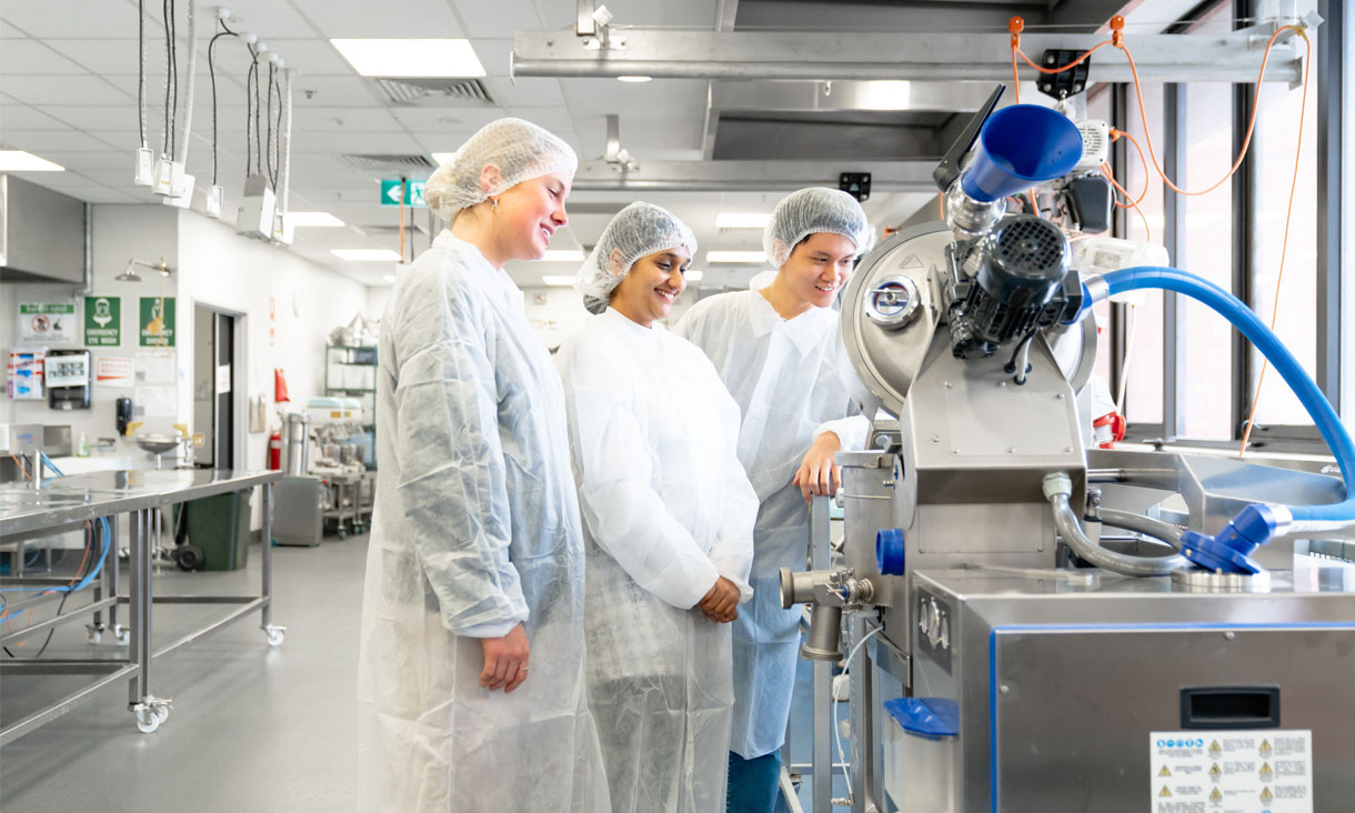 Three RMIT students at the food lab in Bundoora.