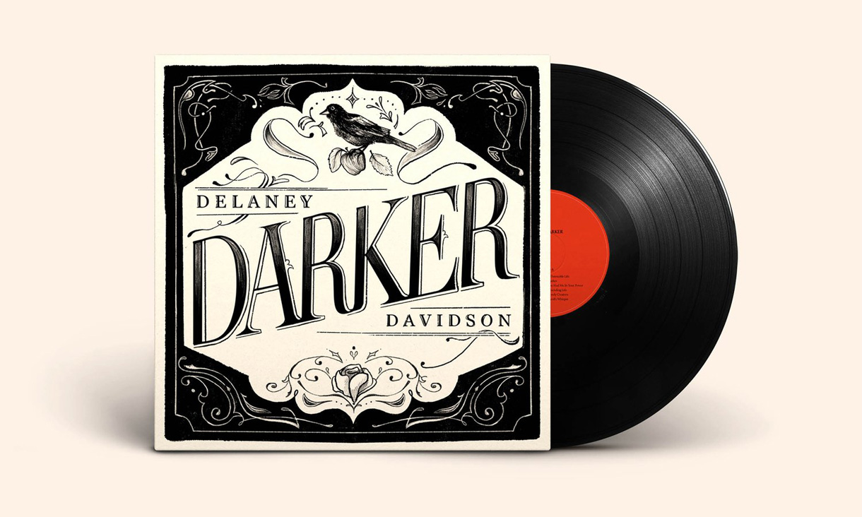 A black and red vinyl peeks out from a black and white vinyl cover titled "Delaney Darker Davidson" on a cream background.