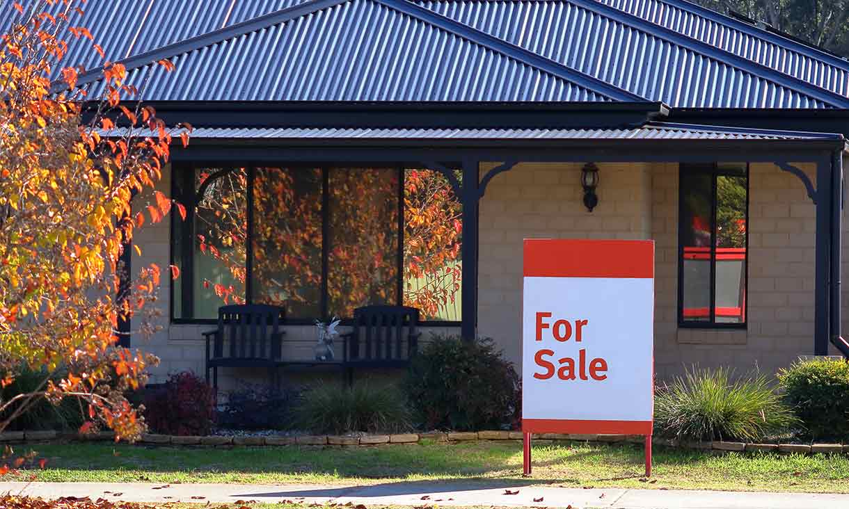 For sale sign outside a house.