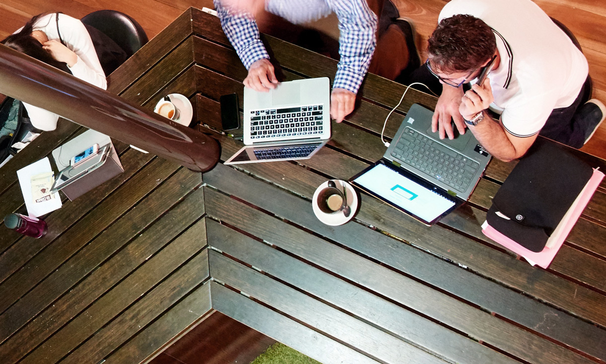 Students working on laptops in cafe