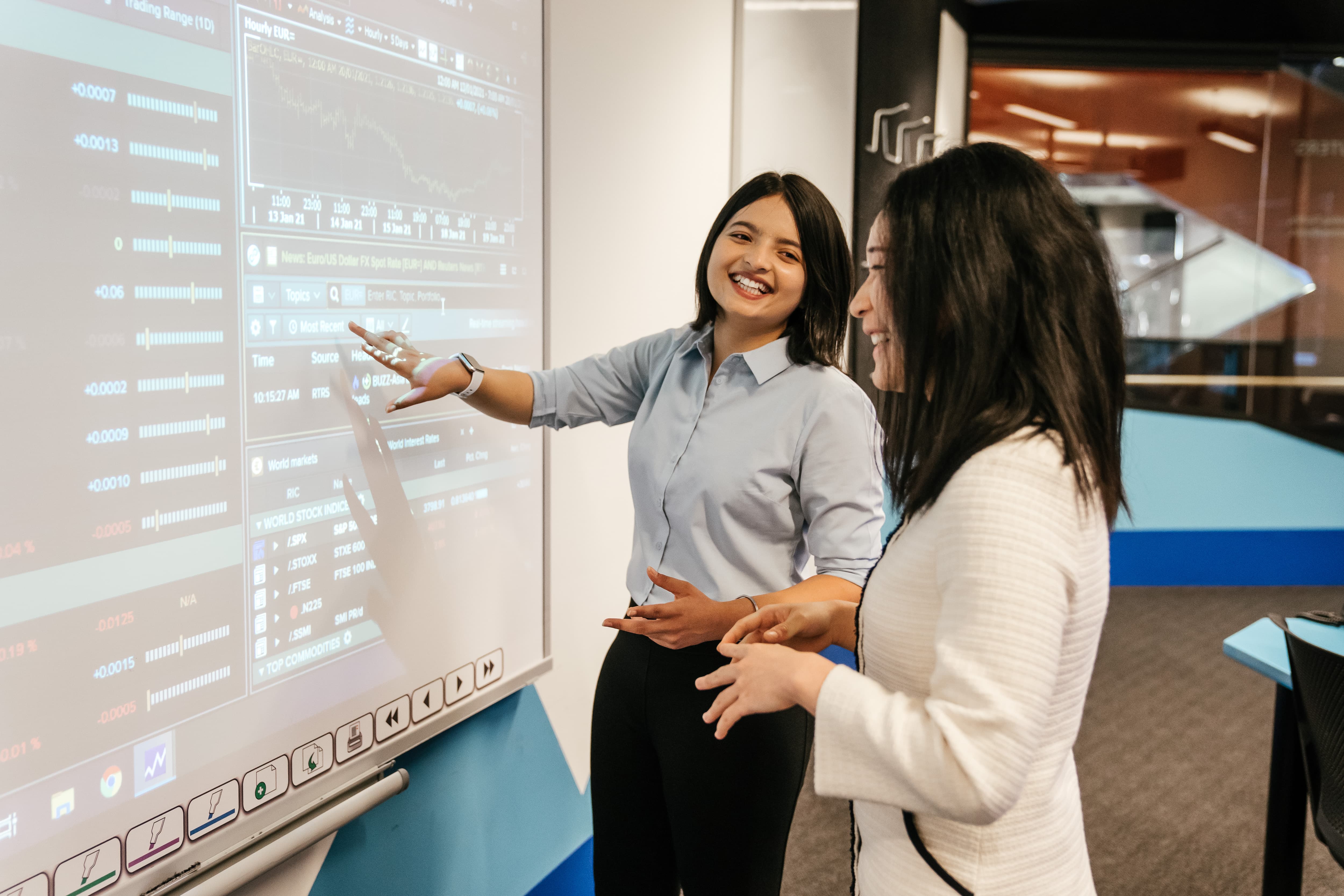 Teacher and student examining a projected chart