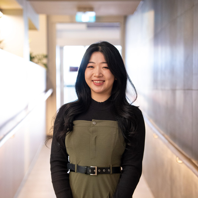 A portrait photograph of Cecilia smiling and looking directly at the camera.