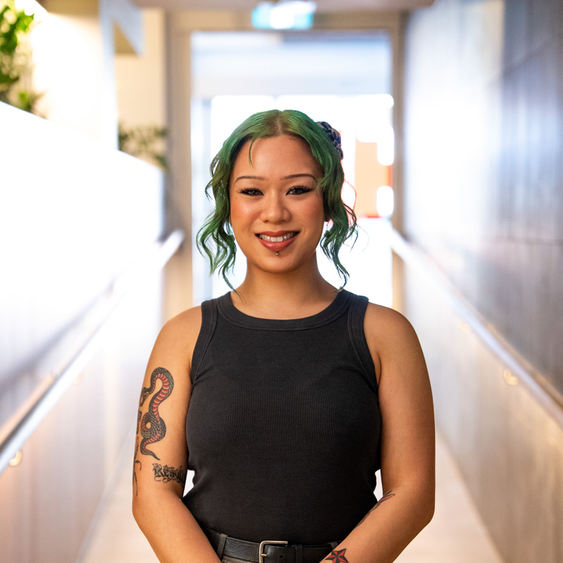 A portrait photograph of Renee smiling and looking directly at the camera.