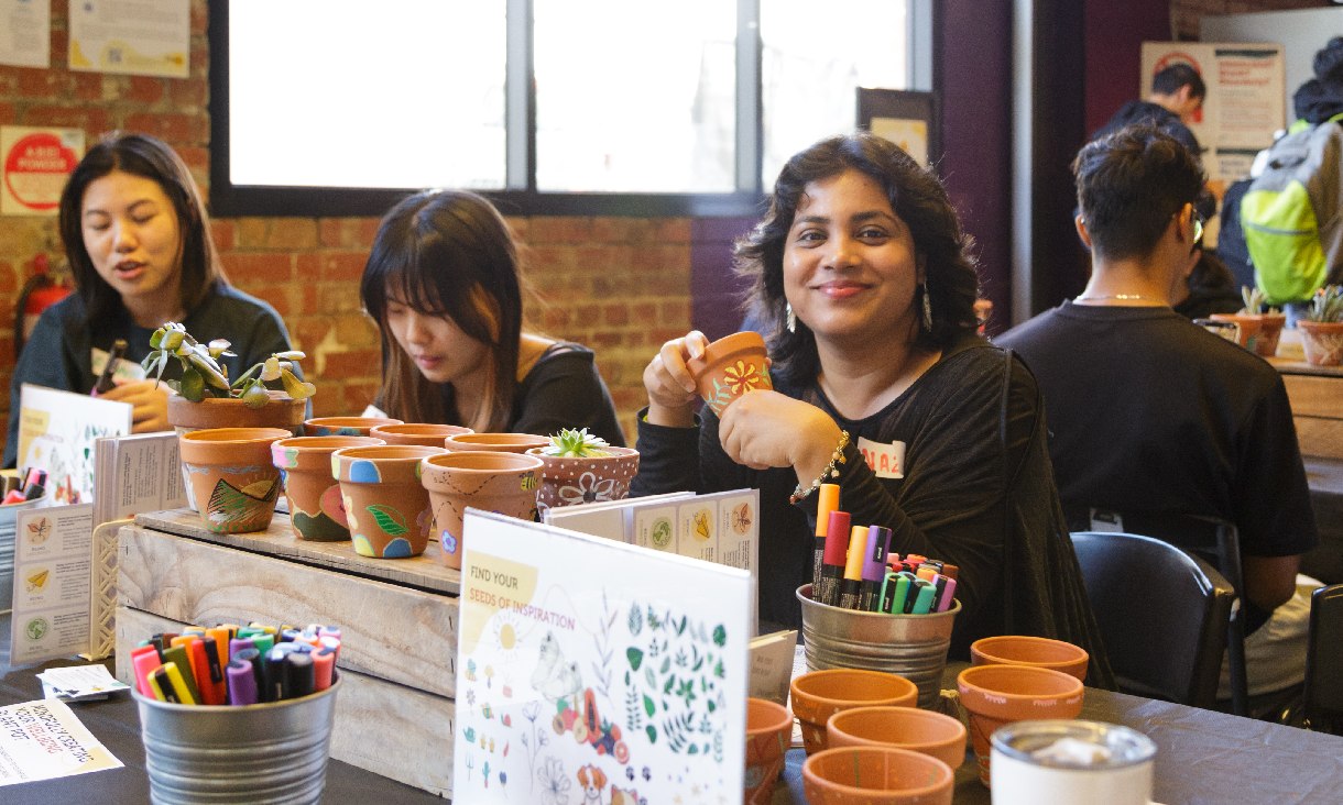 Students taking part in a plant pot painting session as part of an RMIT club