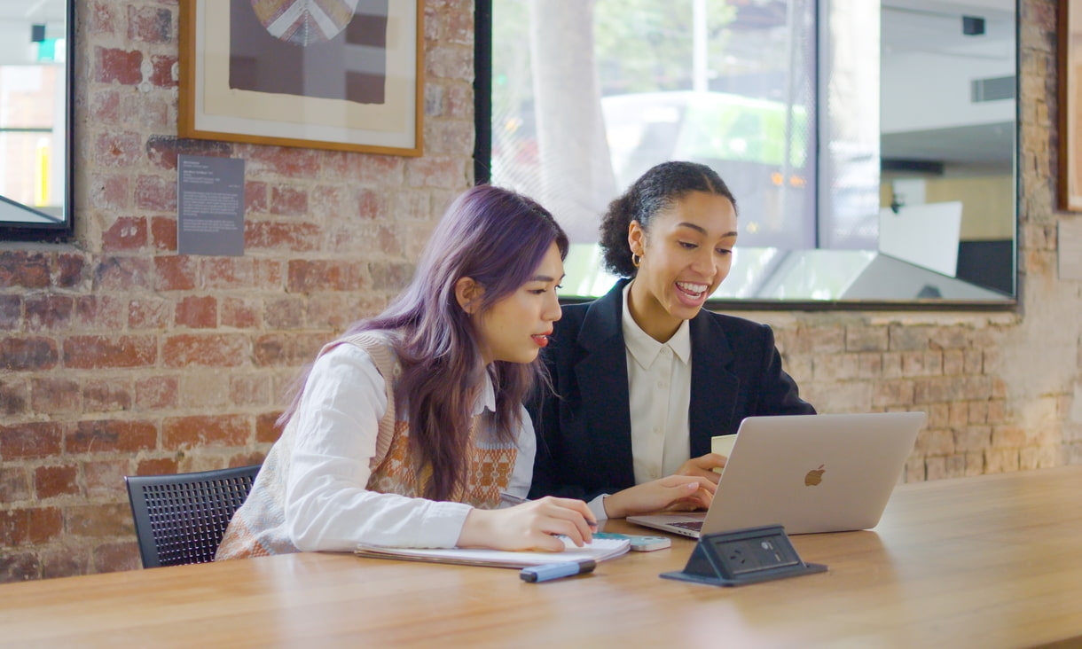 Two business students study together