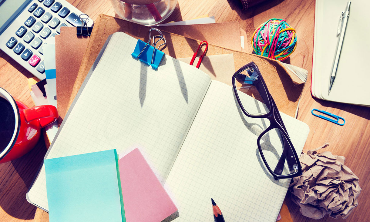 Designer's desk with architectural tools and notebook