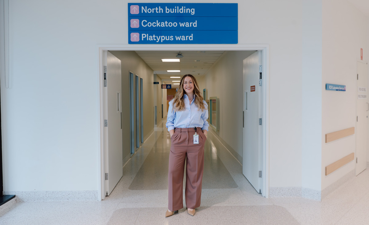 RMIT alumni Carmen Barry standing in the a hospital corridor