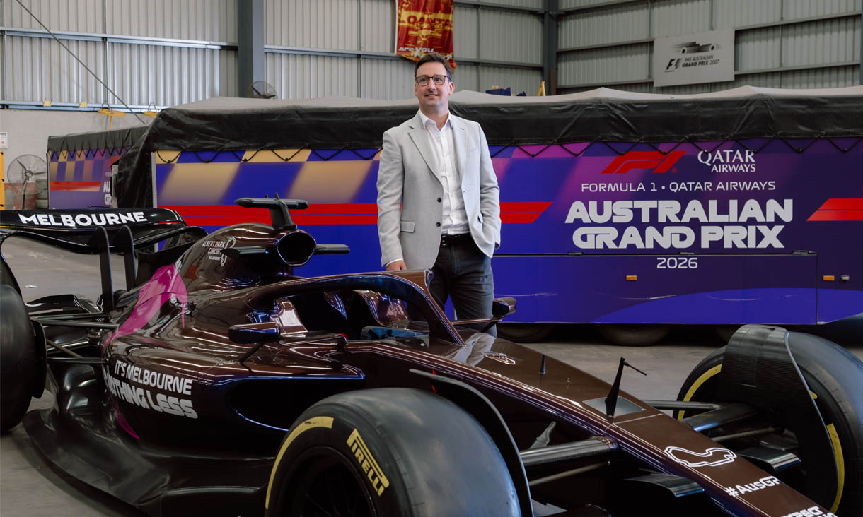 RMIT alumni Dave Carrigan behind a formula 1 car