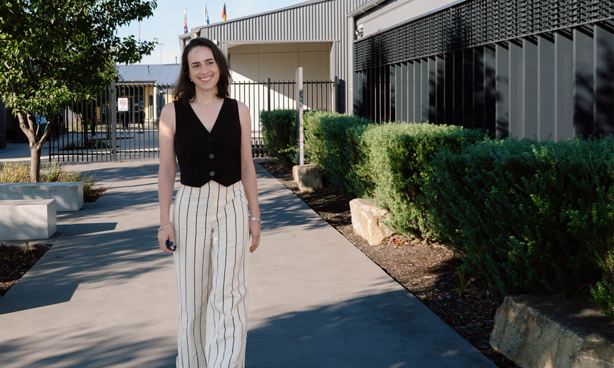 RMIT alumni Natalie Gelati walking across a secondary school campus