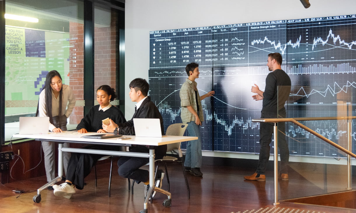 Group of students smiling in a group in front of RMIT buildings