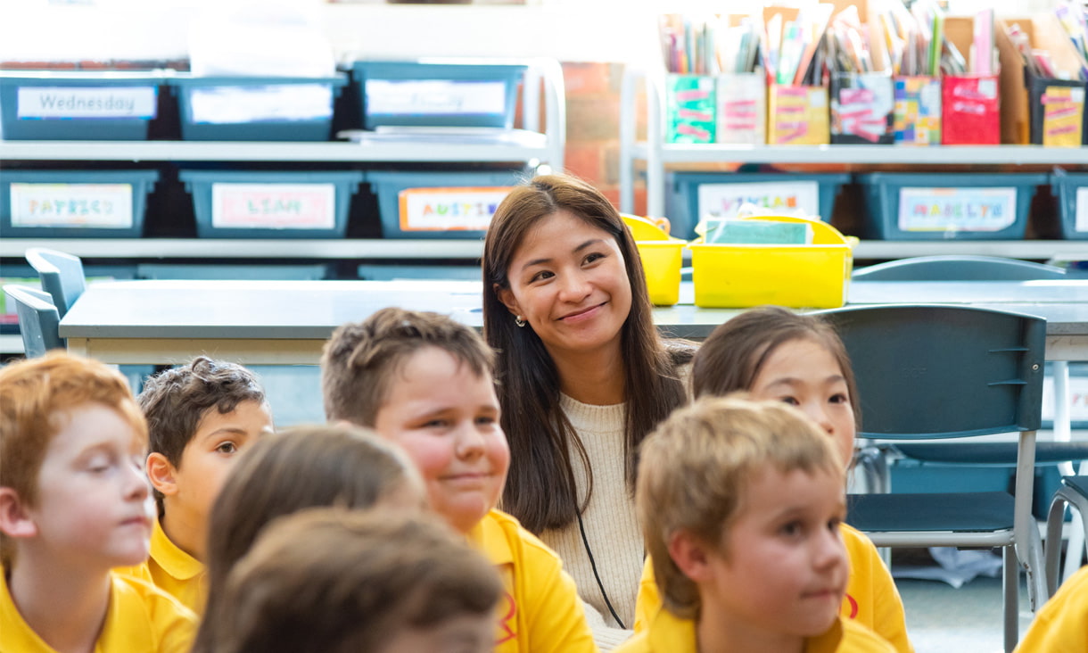 An RMIT Education student sitting amongst primary school students