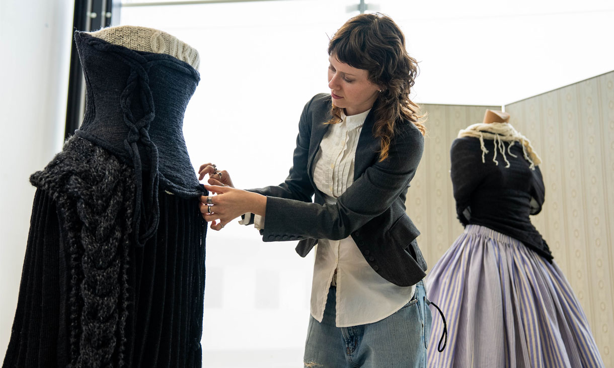 An RMIT fashion student working on a costume on a mannequin