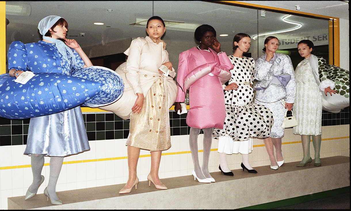 Six female fashion models on the runway