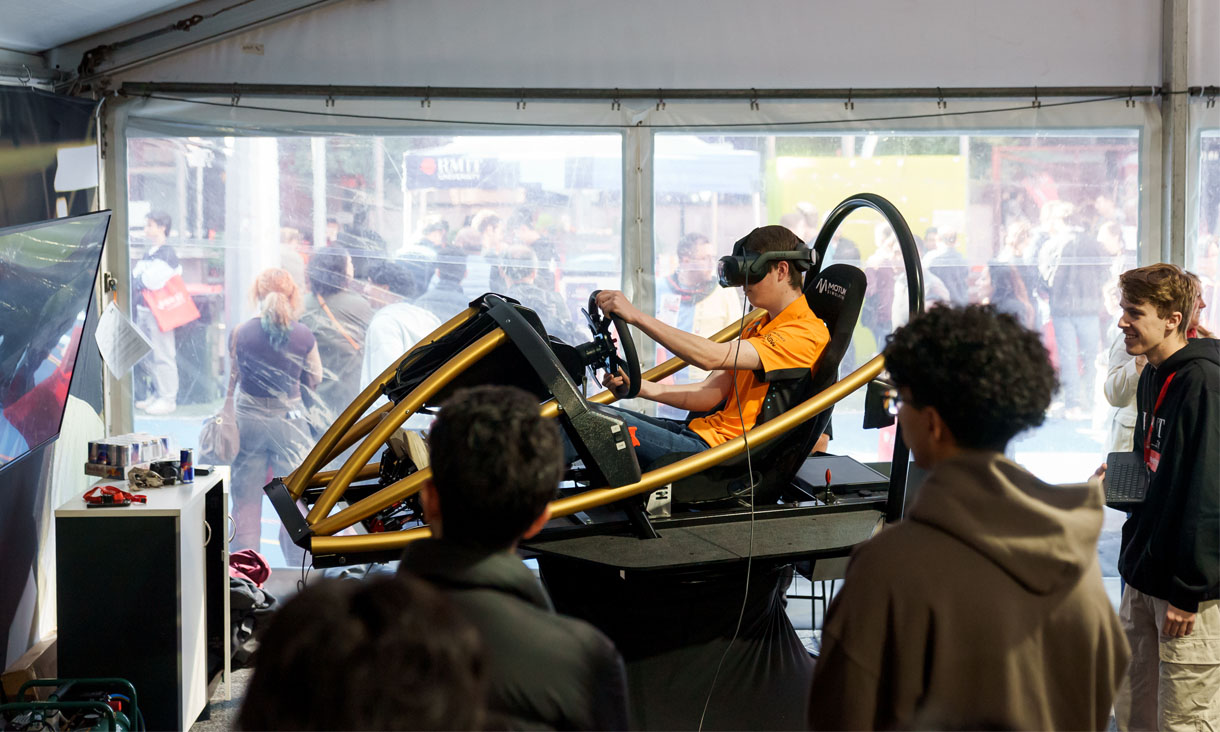 A school student test drives a VR racing experience at RMIT Open Day
