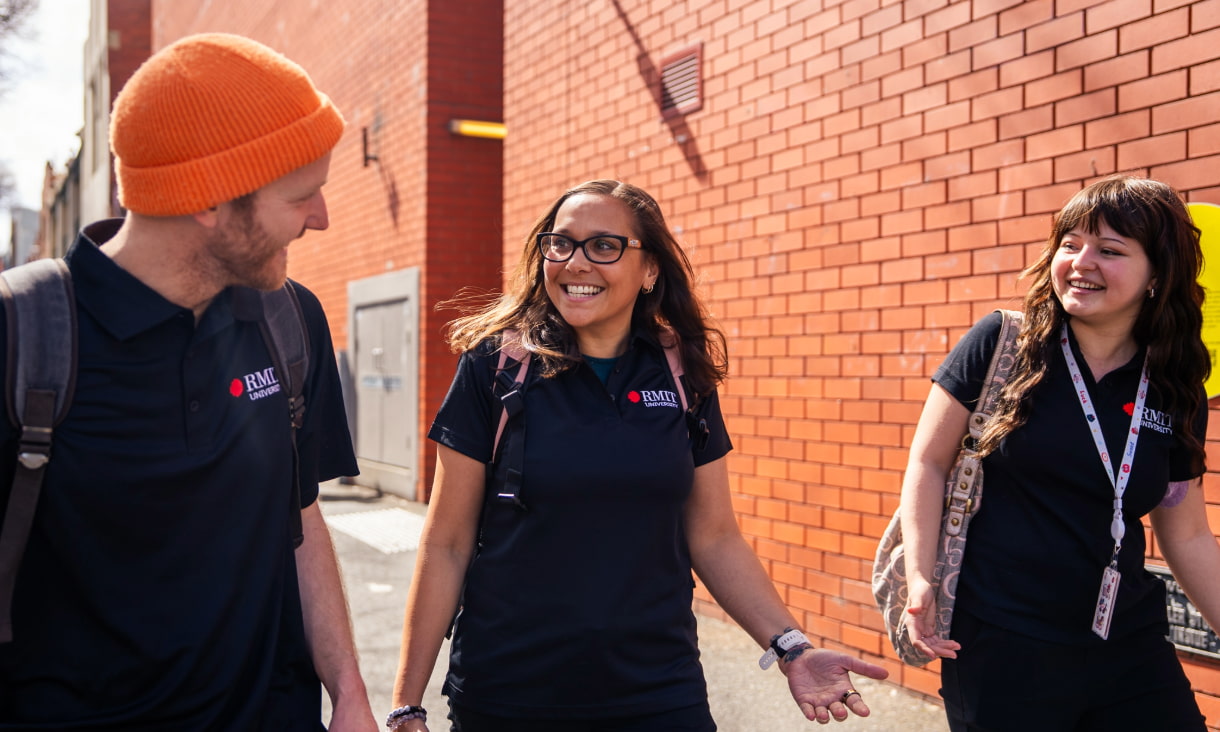 Three RMIT students walking across the Bundoora campus