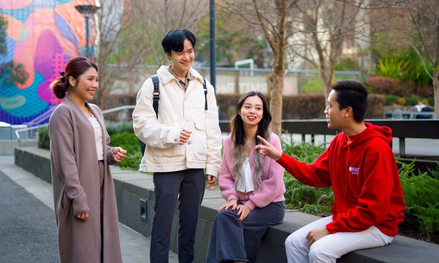 Four students talking together at the RMIT Melbourne City campus