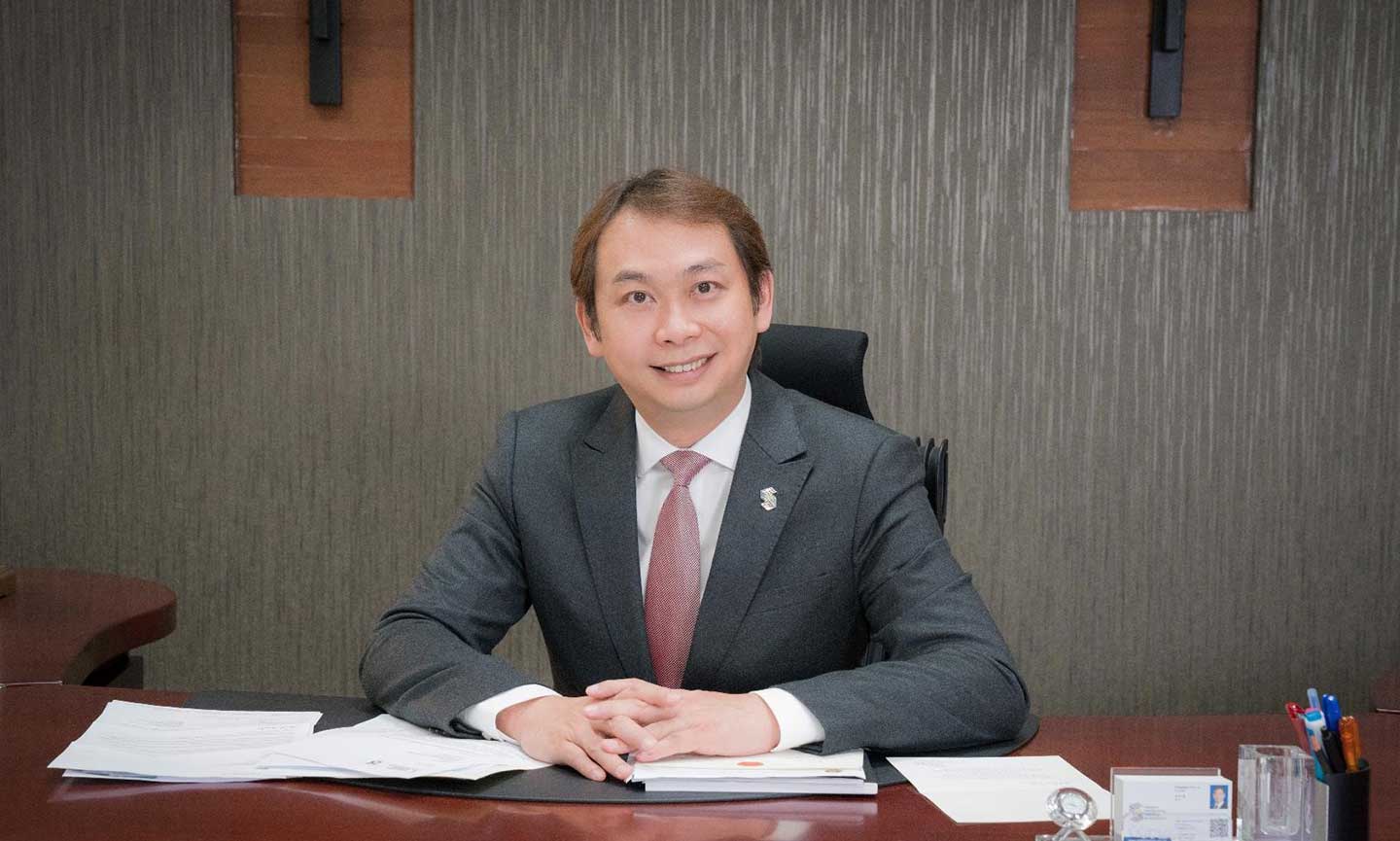 Douglas Foo sitting at desk
