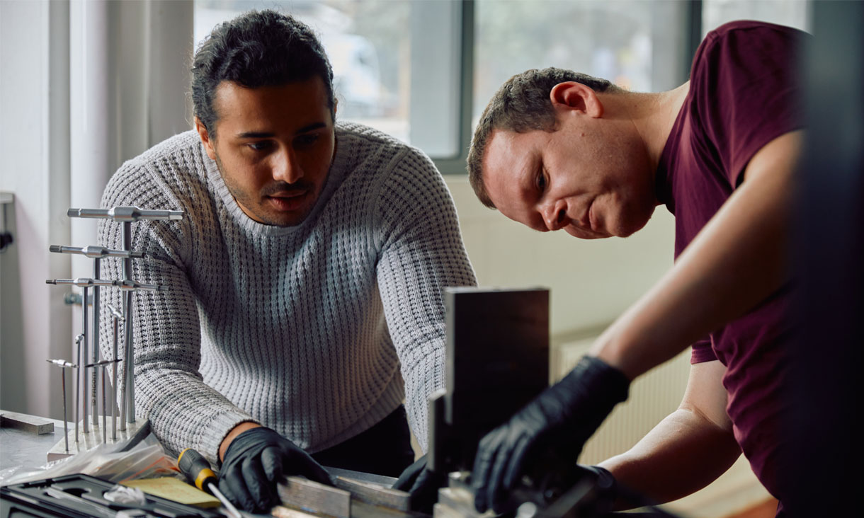 Two engineering students working on a project in the workshop
