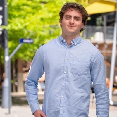 Portrait of a male in a blue shirt with a blurred background. 