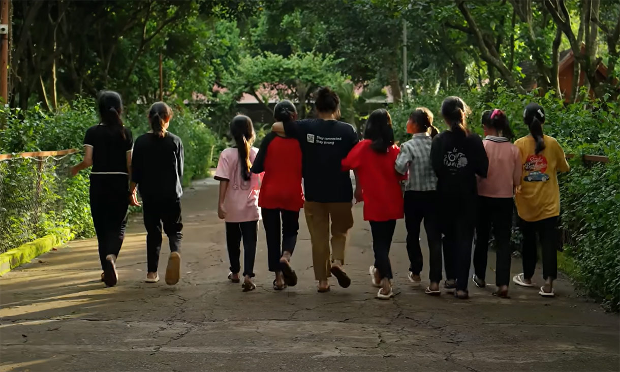 A group of students outdoors, walking away from the camera
