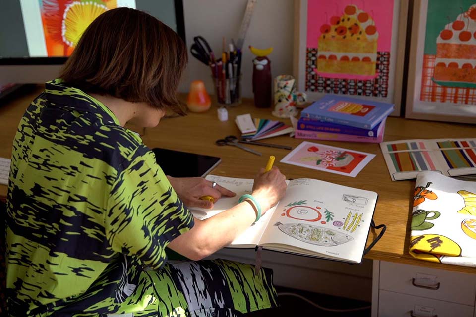 Female student drawing in notebook