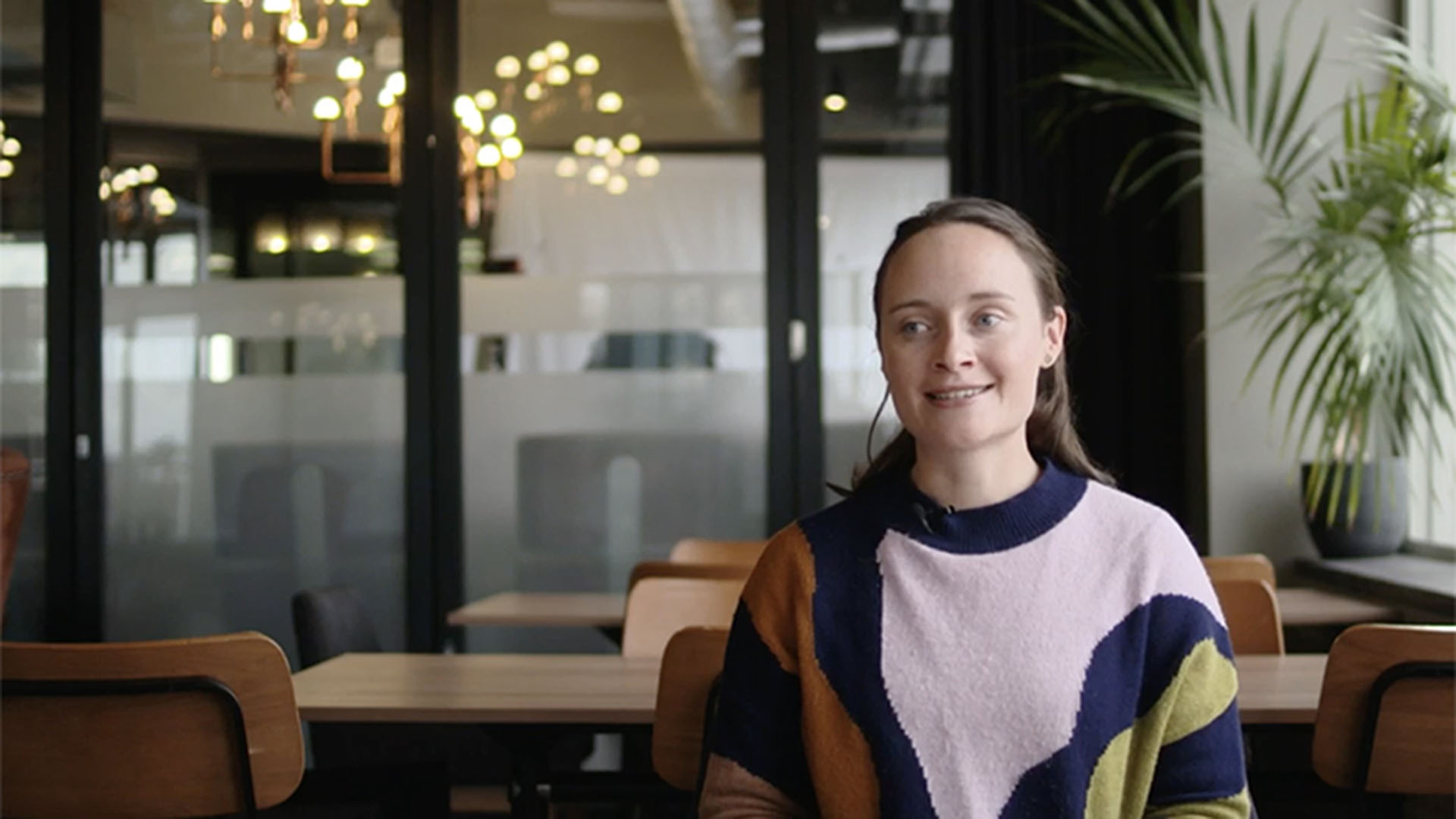 Tenille Gilbert, looking towards camera, seated inside