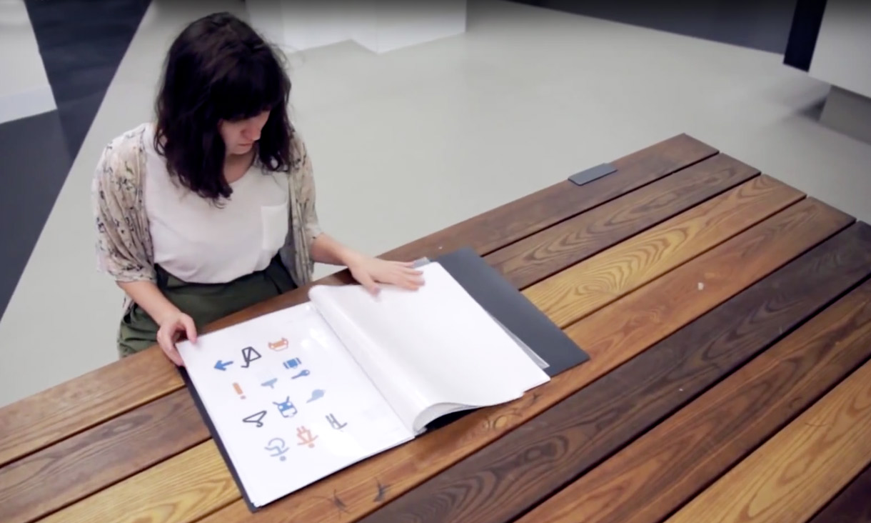 Female student looking at an art folio 