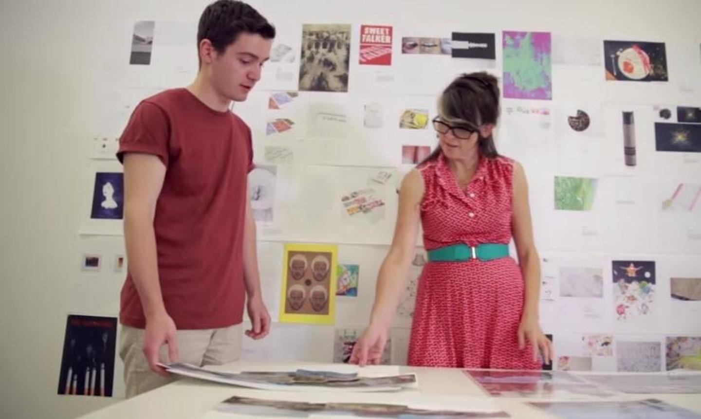 two students looking at artwork