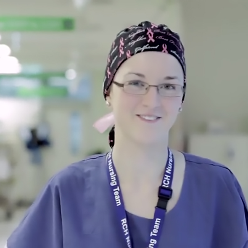 Elizabeth Canobio, RMIT Bachelor of Nursing graduate, looking towards camera, inside a hosptial ward, wearing a lanyard around her neck.