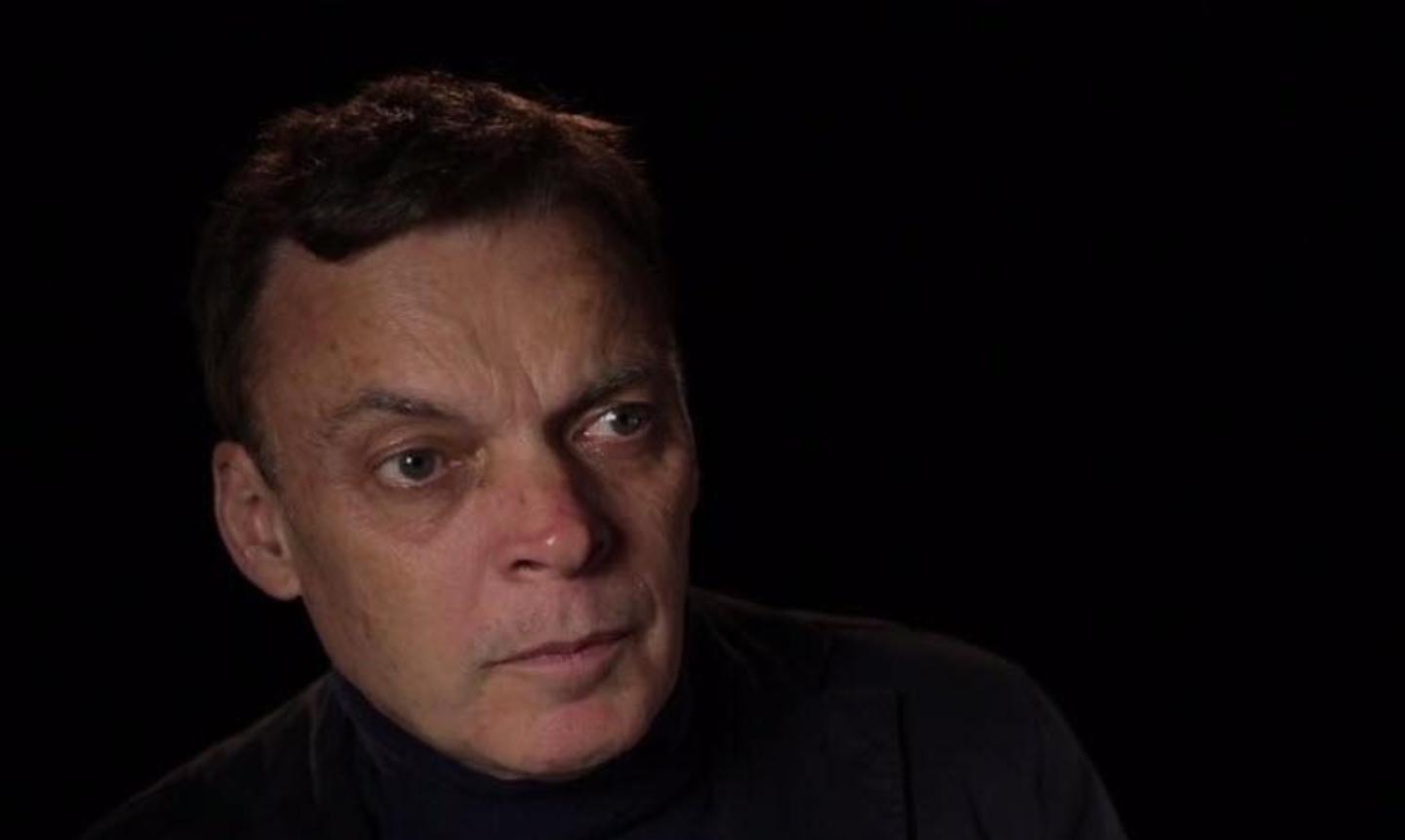 Author Graeme Simsion talking against a black background