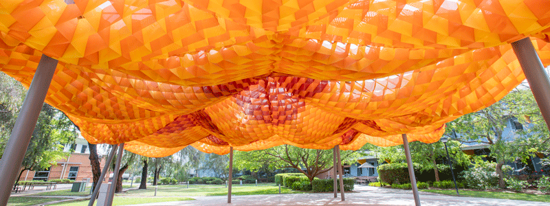 Photograph of the underside of an orange pavilion. 