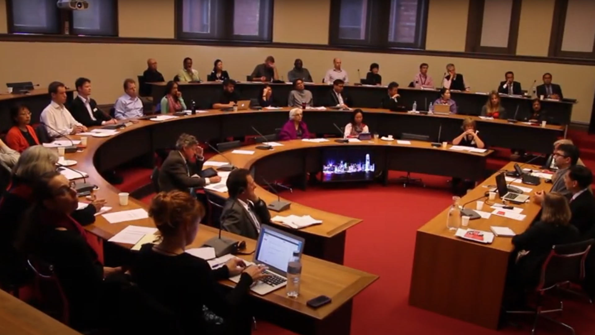 Students sitting around large circular table space in a conference style setting