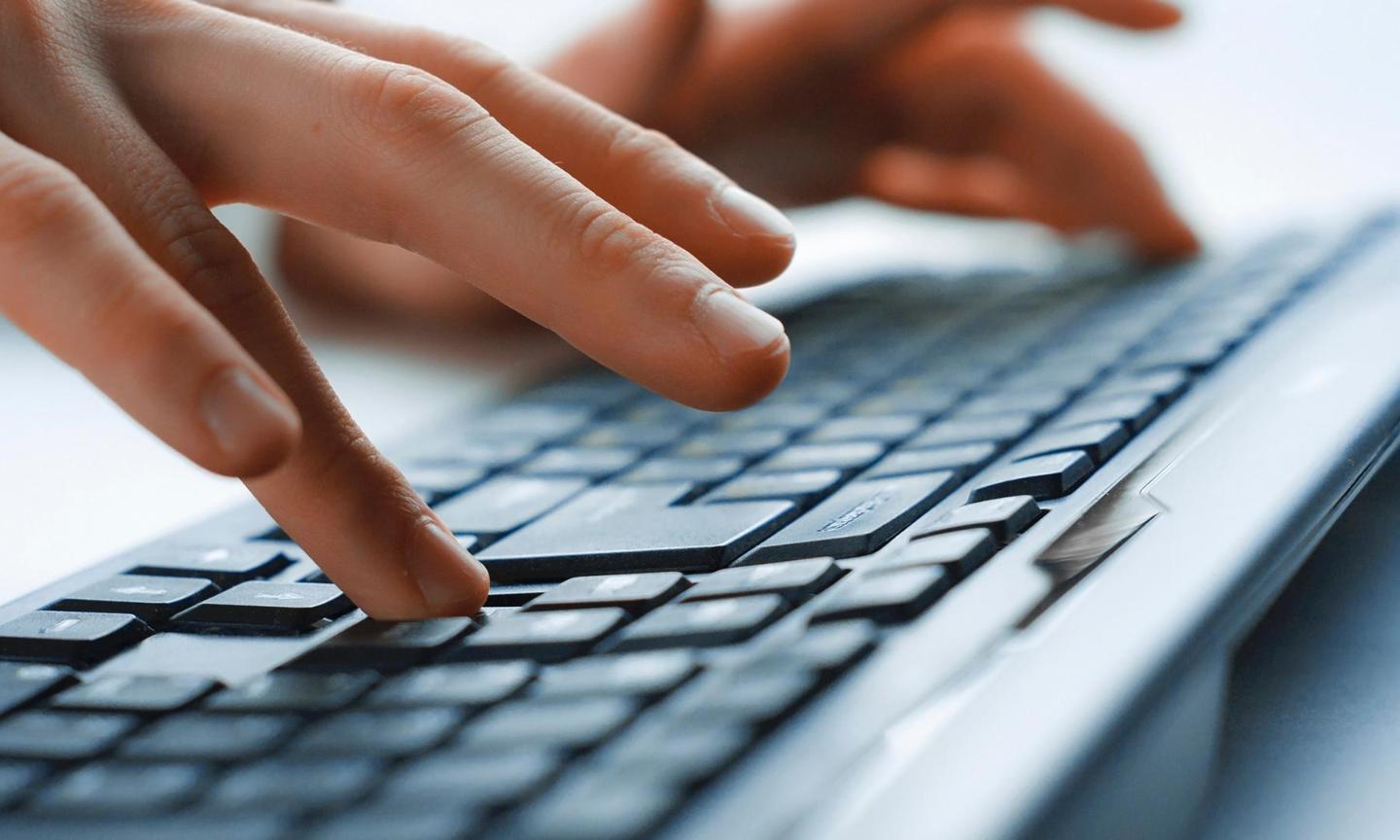 Hands typing on keyboard