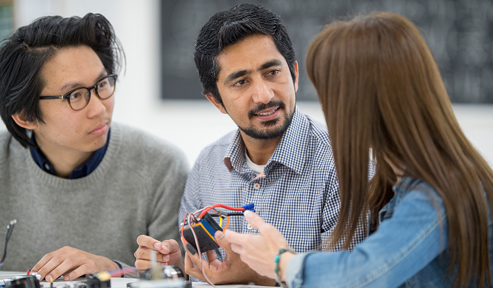 Engineering professionals discussing object 