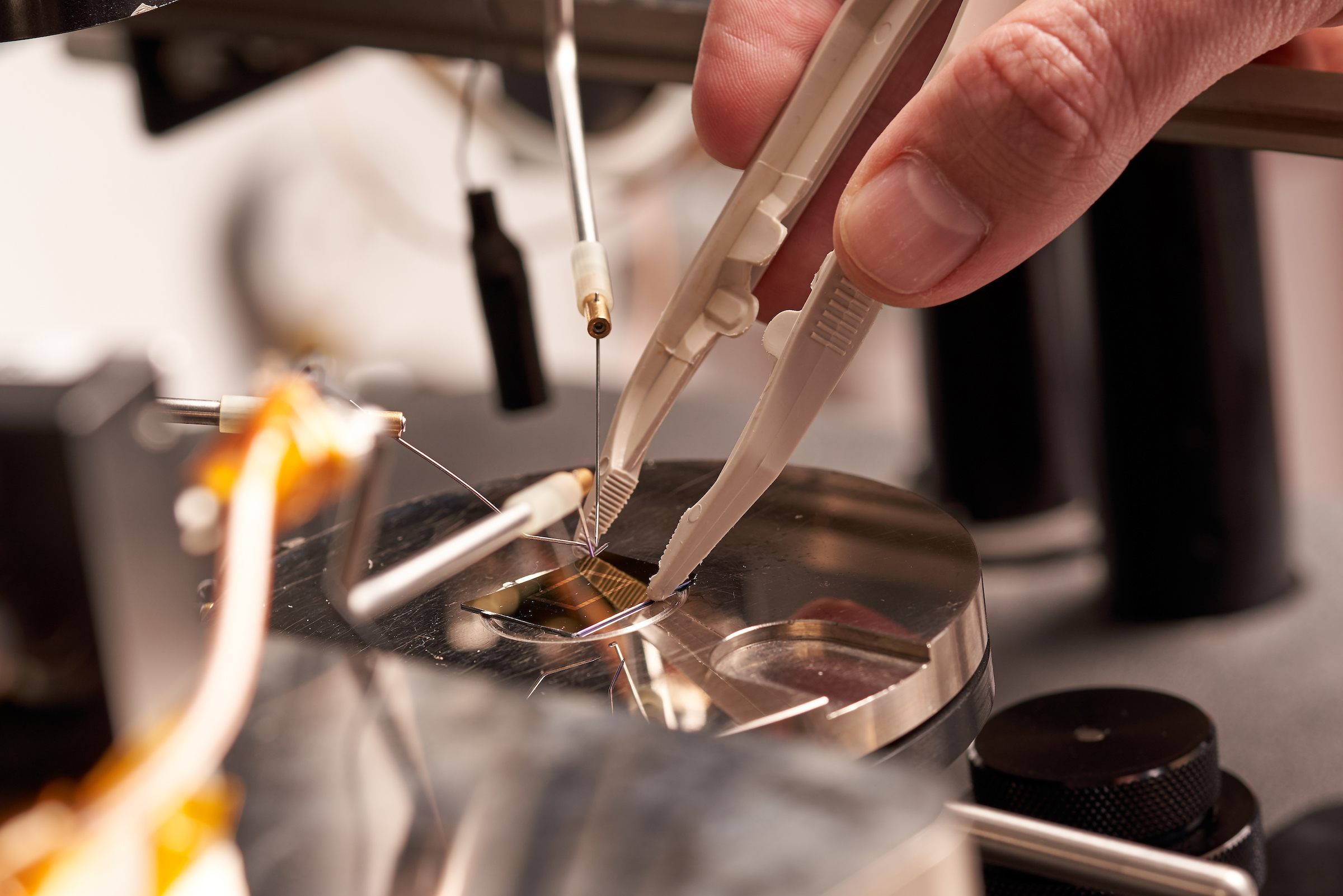 electronic chip being touched with tweezers