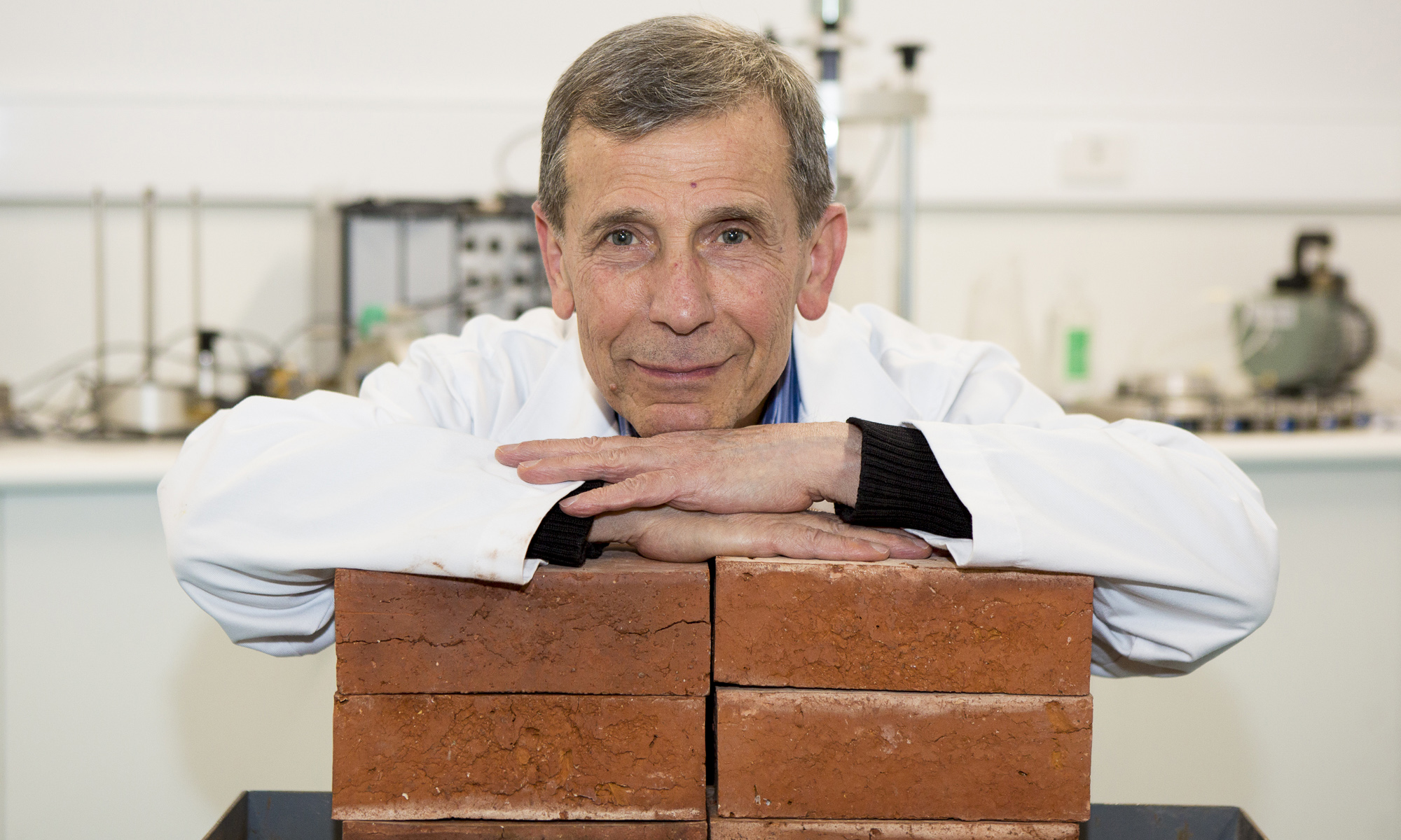 Associate Professor Abbas Mohajerani with bricks made with cigarette butts.
