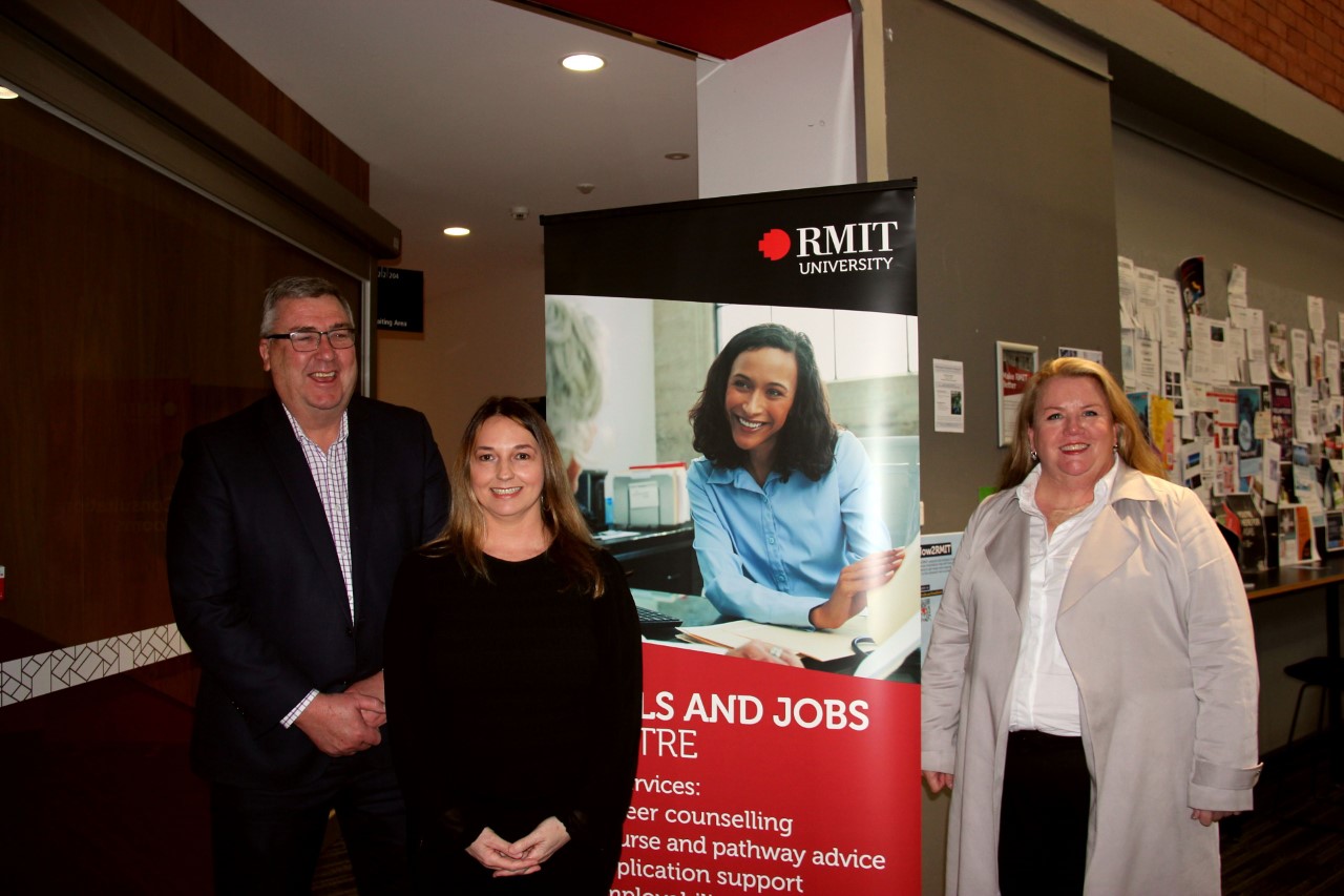 Craig Robertson, Cherie Ward and Mish Eastman stand in front of the new Jobs and Skills Centre banner.