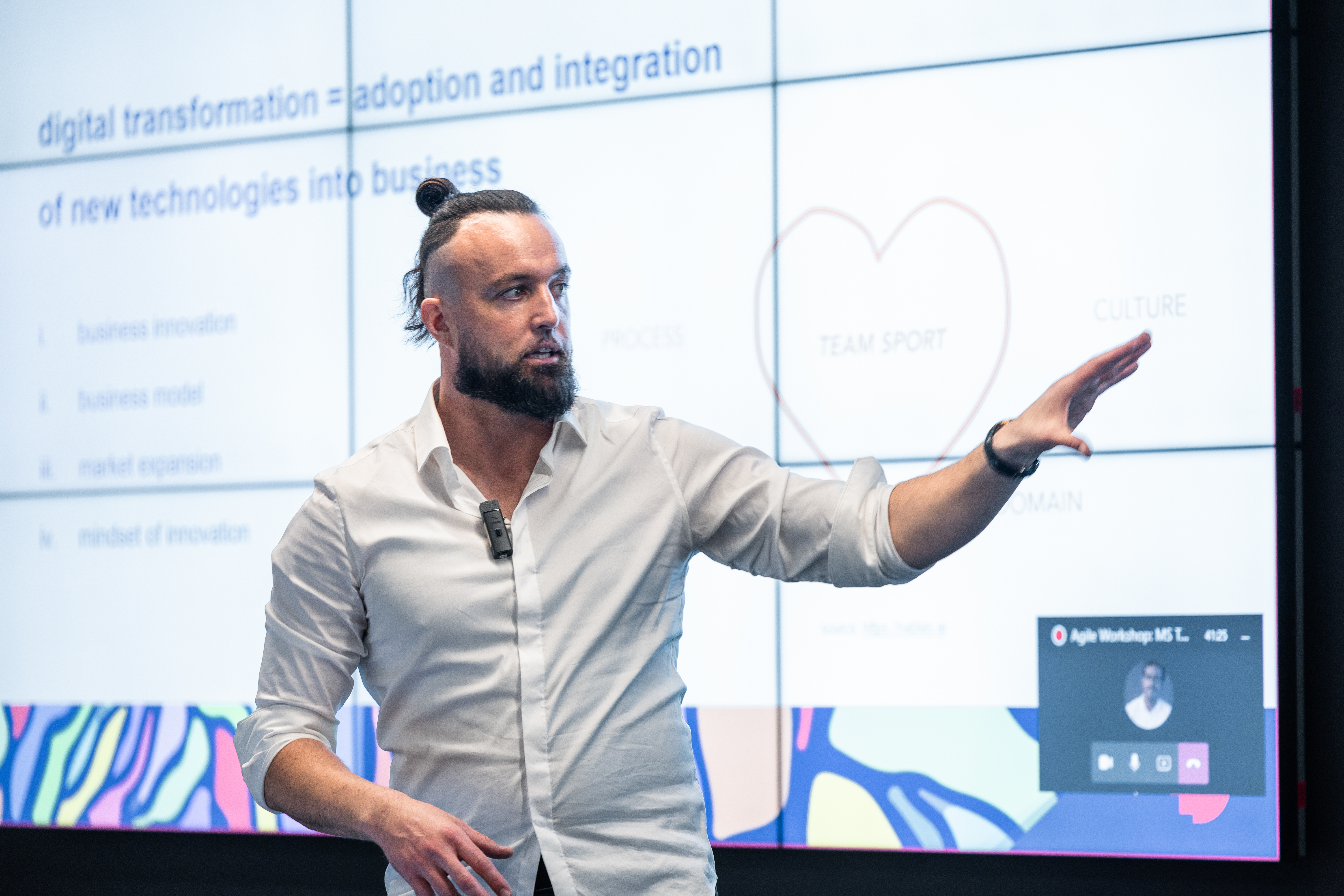 Tomas Turek presents in front of a presentation screen.