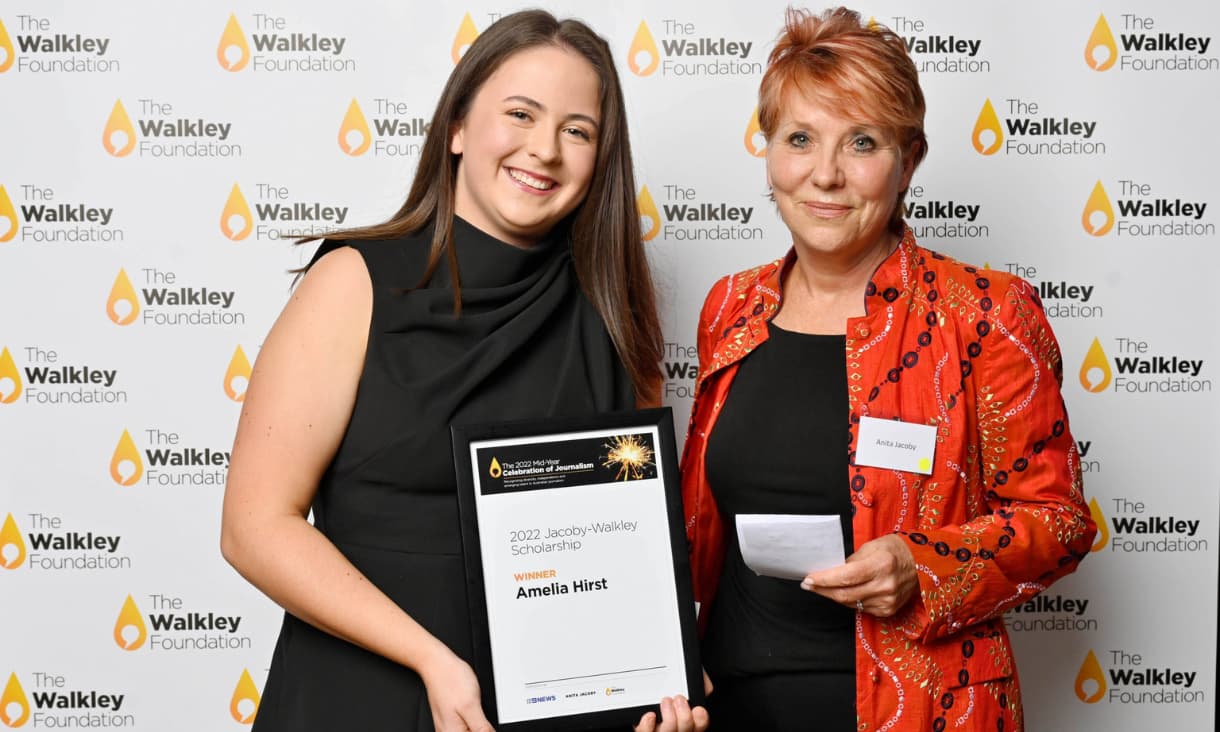 Amelia Hirst with Anita Jacoby in front of a branded media wall.